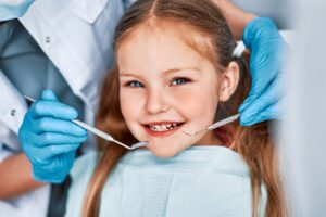 Child receiving dental sealant treatment during a preventive dental visit