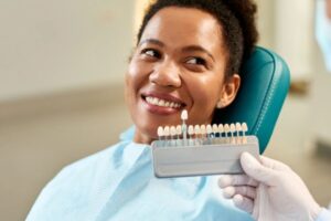 Dentist examining veneers during a routine dental checkup