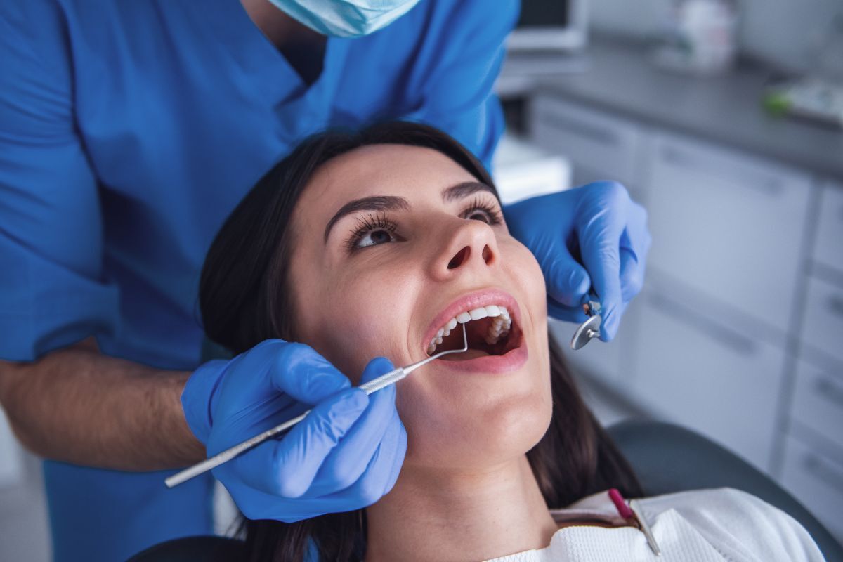 Dentist examining patient's teeth during first dental visit in Silverdale.